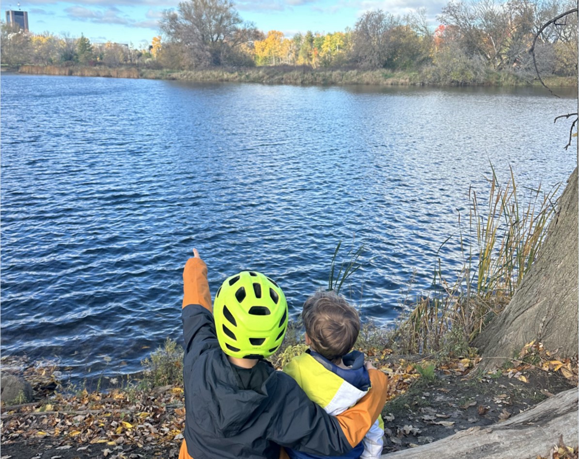 two children sitting together looking at the horizon