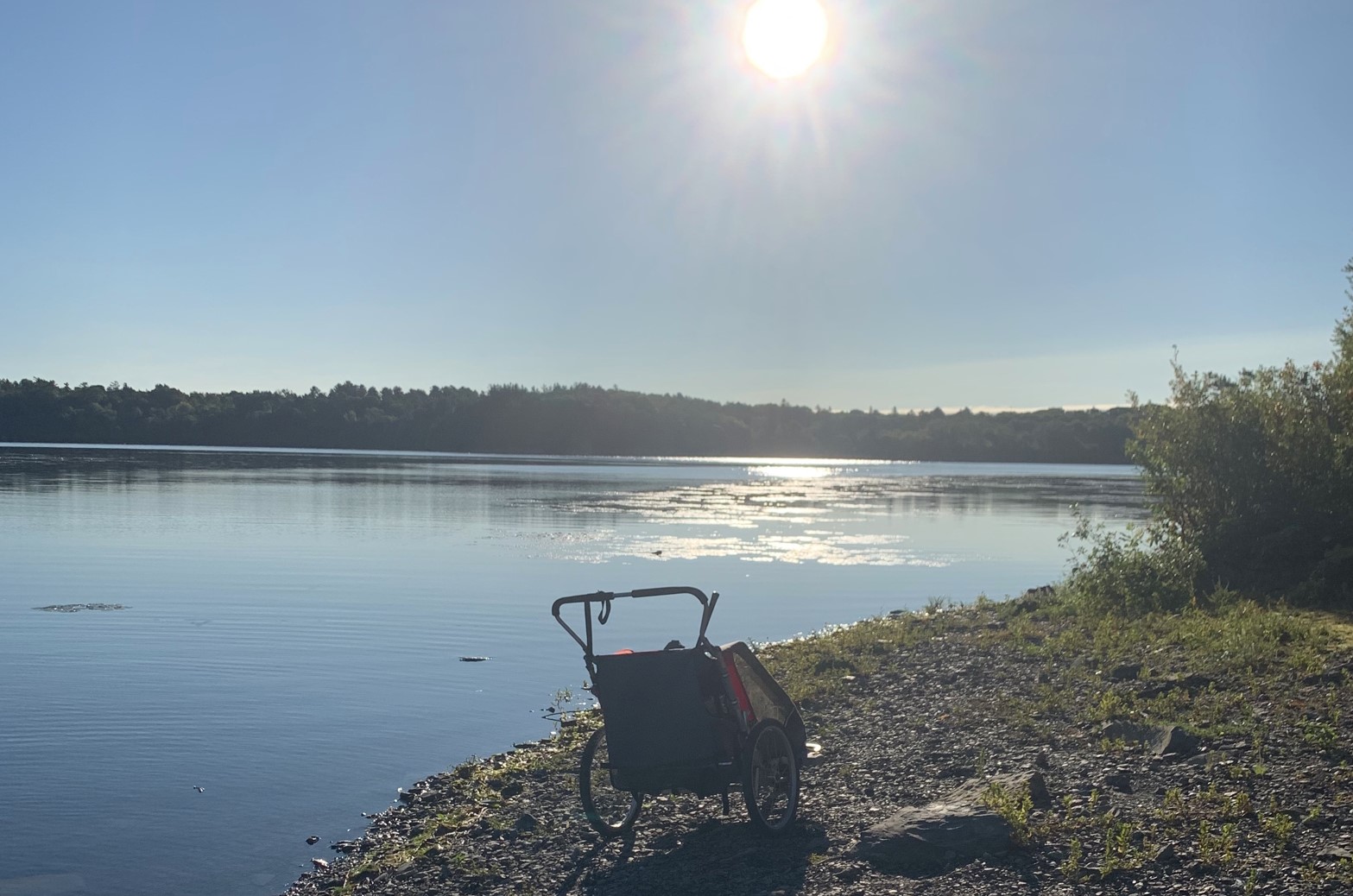 Jogging stroller, besides a body of water